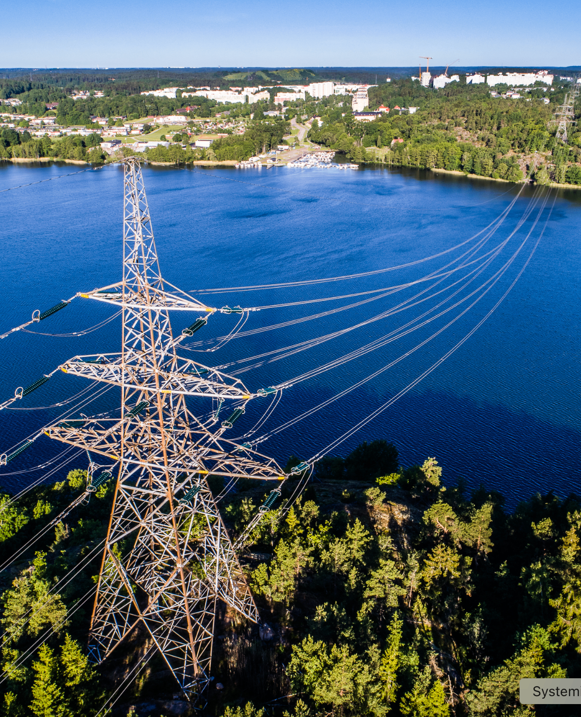 Helicopter next to a power line above water